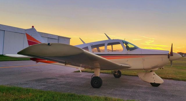 Piper Cherokee (N6355J) - On the ramp with a colorful sunset behind 