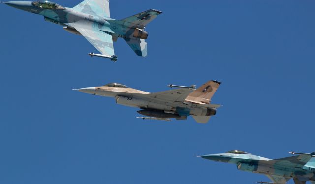 Lockheed F-16 Fighting Falcon (90-0944) - TopGun Instructor pilot USAF Maj. K. R. "Polar" Amerine begins her left break to peel away from a section of F-16 Fighting Falcons as the section returns to NAS Fallon after completing a TopGun training mission in this photo taken earlier this year.  Maj. Amerine, flying NAWDCs "Side Five Five," was completing her "Last Flight" ... the final time she would be participating in a TopGun exercise.br /After leading her section into the left break, "Polar" remained in the air while the other two Vipers seen following her here touched down and landed.  Then, "Polar" made three more passes, including one in which she "buzzed" (grin) the tower in the same way that "Maverick" (Tom Cruise) had done in the movie Top Gun.  And incidentally, the control tower at NAS Fallon is the actual tower seen in the Tom Cruise movie.  Although the setting of the film is at Miramar, the scene in which "Maverick" smokes past the control tower was shot at NAS Fallon.br /At the time this photo was taken, NAWDC was still known as NSAWC (as can be seen on the underside of the center Viper, Side Five Tree).br /After landing, "Polar" was "met" on the ramp by her fellow TG pilots ... with lots of ice cube-filled water buckets and many well-shaken champagne bottles.  Id like to share those pics, too; however, there are no aircraft in the shots.  lol 