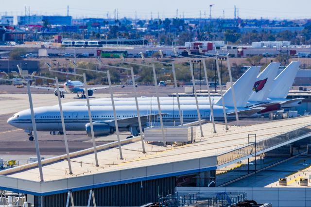 Boeing 777-200 (N867DA) - The Arizona Cardinals 777-200 and two Gridiron Air 777-200s parked at PHX on 2/16/23. Taken with a Canon R7 and Tamron 150-600 G2 lens.