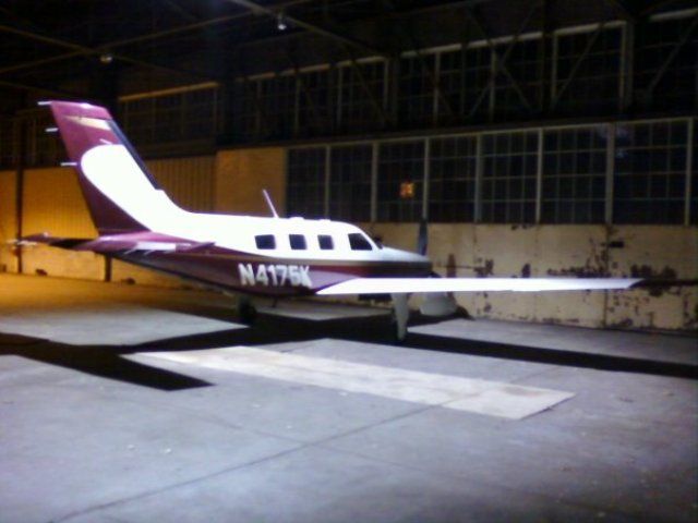 Piper Malibu Mirage (N4175K) - Beautiful Malibu at SMD. Just finished a flight for the day, but unfortunately all I had on my was the camera on my cell. Just thought the lighting looked neat in the hangar.