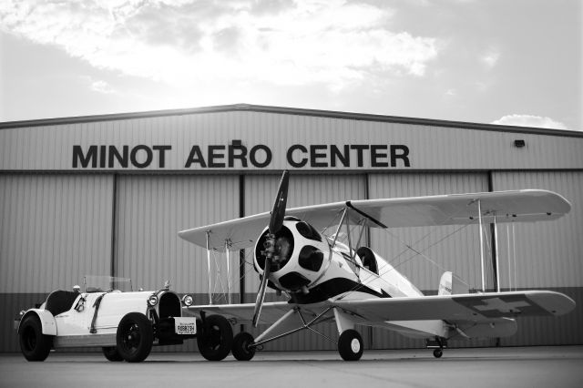 — — - büker and bugatti in front of KMOT - Minot Aero Center Hangar