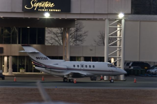 Hawker 800 (N832QS) - Waiting for an early morning departue out front of a charter service ay KPDK.