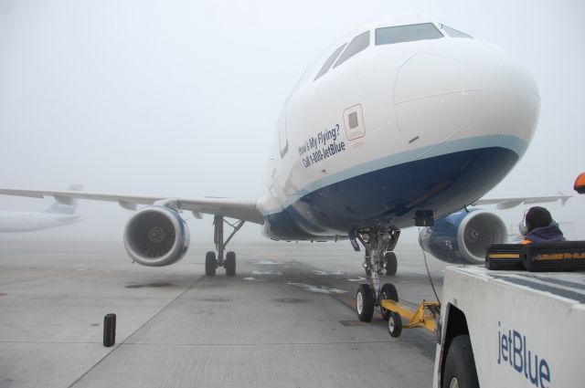 Airbus A320 (N715JB) - Waiting to push Flight 290 to KSEA from Pad 4 in the fog on the morning of December 5th, 2012