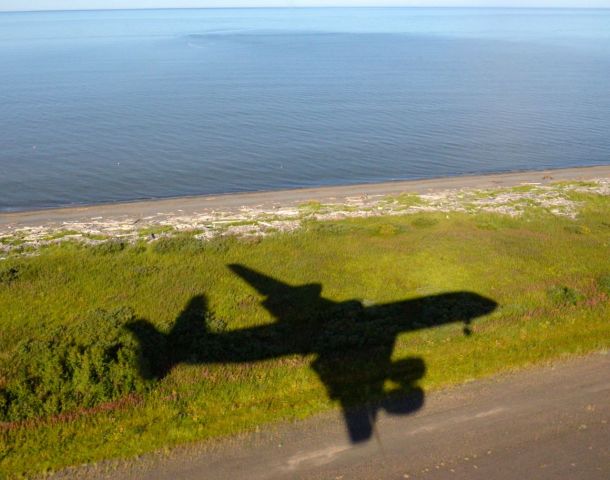 McDonnell Douglas DC-8-70 (N817NA) - Shadow of NASA 817, McDonnell Douglas DC-8  on a deliberate missed approach to R33 Unalakleet airport while on a science mission (ABoVE) measuring atmospheric trace gasses with lasers over Alaska