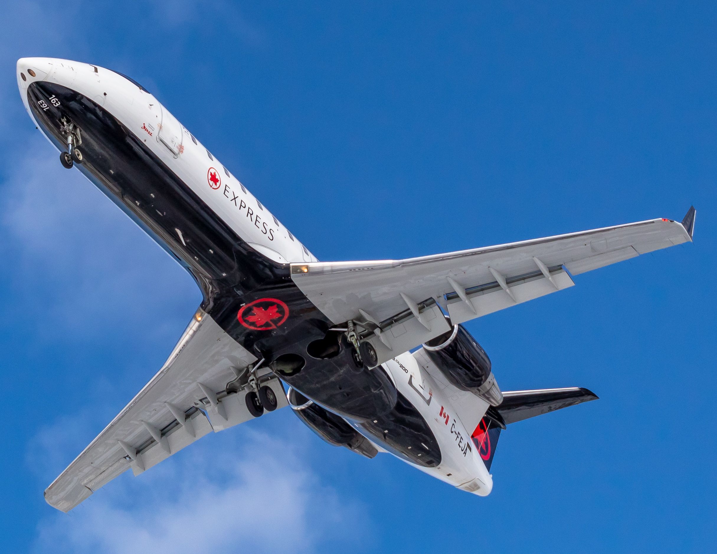 Canadair Regional Jet CRJ-200 (C-FEJA) - A Jazz Air CRJ-200 overhead to land at Montreal.
