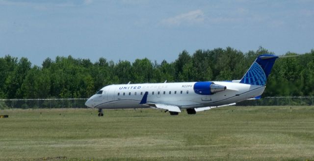 Canadair Regional Jet CRJ-200 (N221PS) - Taxiing to parking is this 2004 United Express Canadair Regional Jet 200ER from the Spring of 2021.