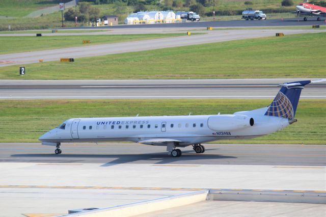 Embraer ERJ-145 (N13988) - Acey on the taxi with a DC-3 in the background