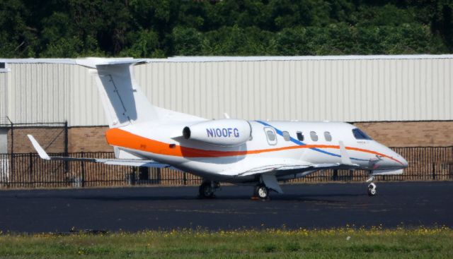 Embraer Phenom 300 (N100FG) - Catching some Tarmac time is this 2011 Embraer 300 EMB-505 in the Summer of 2019.