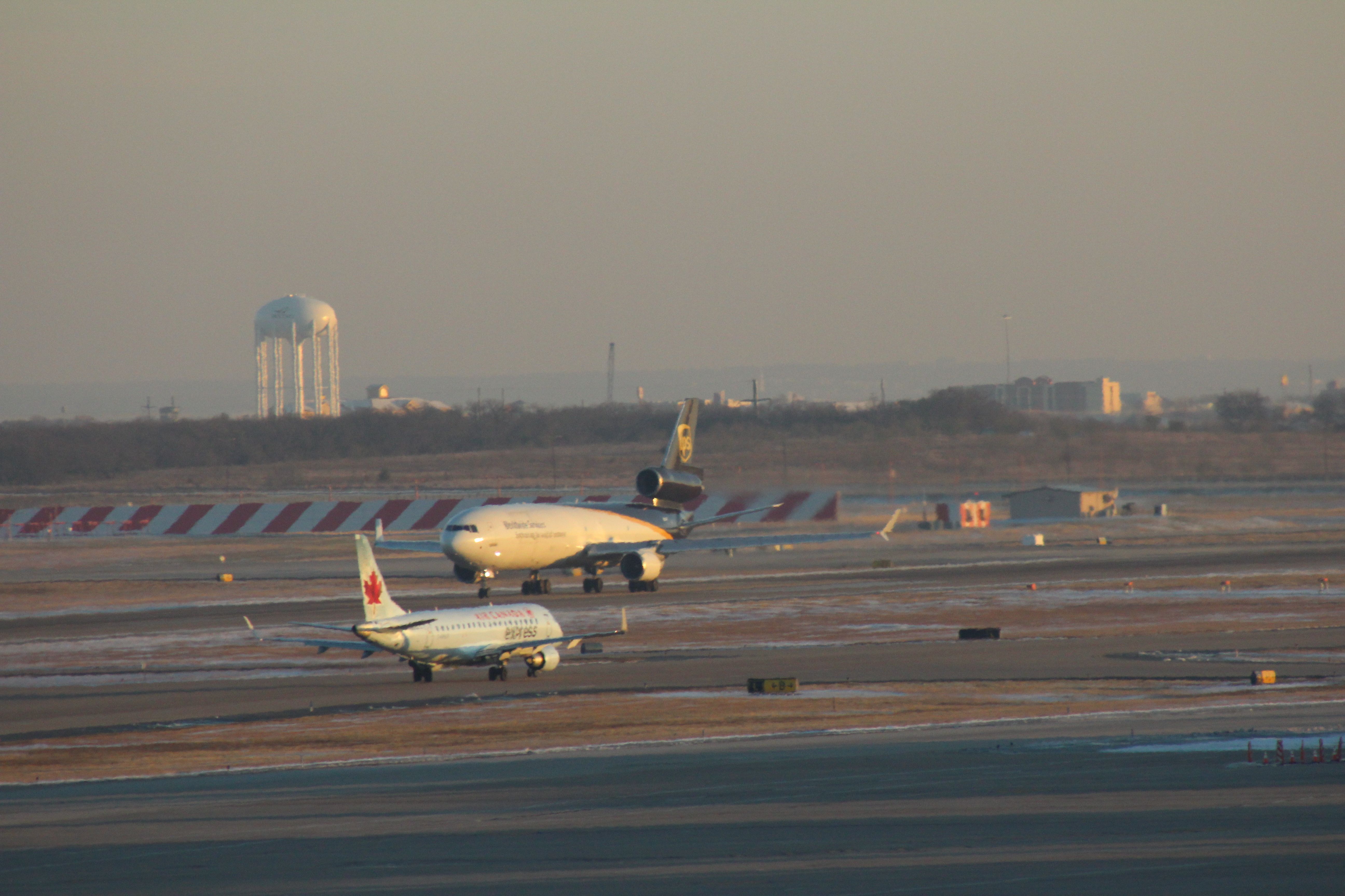 Boeing MD-11 (N283UP) - 121013 UPS on take-off roll Rwy 35L, ACA ERJ190 C-FEJY taxiing out