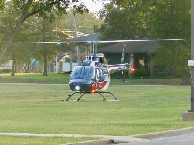 Bell JetRanger (N539AE) - Air Evac 87 in the grass at Bolivar Medical Center preparing to move to the helipad after waiting for Pafford Air One Echo to move