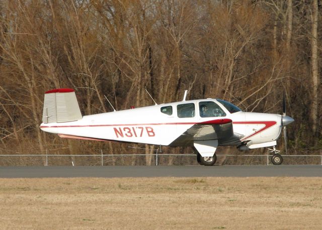 Beechcraft 35 Bonanza (N317B) - 1956 Beech G35 cleared for take off on 14 at Downtown Shreveport. This is a nice old aircraft. V-tails are the coolest!!!