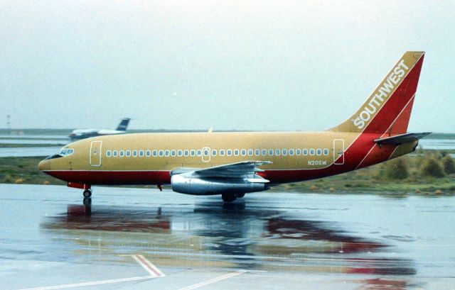 Boeing 737-200 (N20SW) - KOAK_ I rarely post KMart, but this negative just found Aug 2021, and taken back in late 1980s at a rainy Oakland Intl - , I looked up the data on this and I see 2 different entries, so I will not post the LN. This jet had just arrived at Oakland in this photo and headed to the gate. I do not know where this jet flew in from. The engine looks out of place with the bright bare metal. This may be one of the first 3 737s Southwest started jet-airlineservice with.