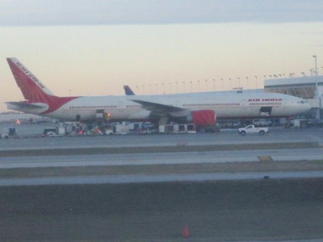 — — - An unknown Boeing 777 of Air India. Taken from inside a United A320.