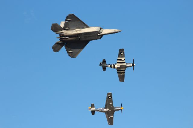 North American P-51 Mustang (AEH74190) - Under a crystal blue sky during the Friday Oshkosh Afternoon Air Show, the Air Force Heritage Flight lead by a F-22 Raptor from Langley AFB & 2 P-51 Mustangs. 