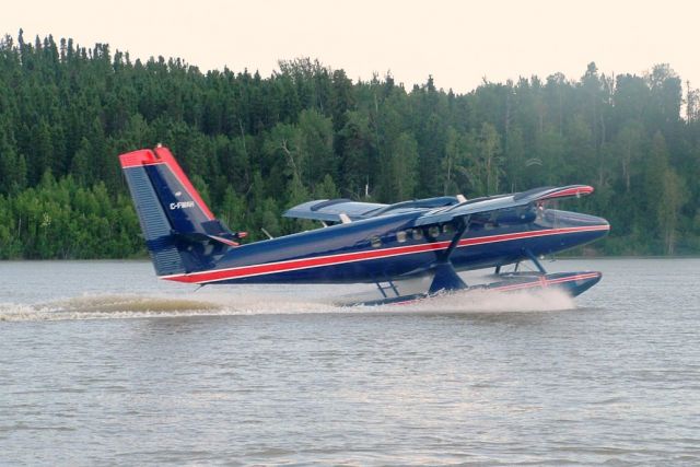 De Havilland Canada Twin Otter (C-FWAH) - Twin Otter CFWAH landing in the Burntwood River, Thompson Manitoba. Owned by the Manitoba Air Services and piloted by James Stewart, this aircraft had been previously owned by Max Ward, founder of Wardair International Ltd., a Canadian airline in the 80s. Damaged in a landing in Great Slave Lake in June, 2000, the Manitoba Government bought the airframe in 2002 and refurbished it. The original Wardair colors have been retained.