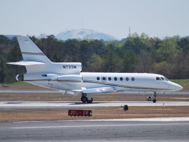 Dassault Falcon 50 (N733M) - JAPC INC arriving runway 21L at KPDK with Stone Mountain in the background - 4/6/13