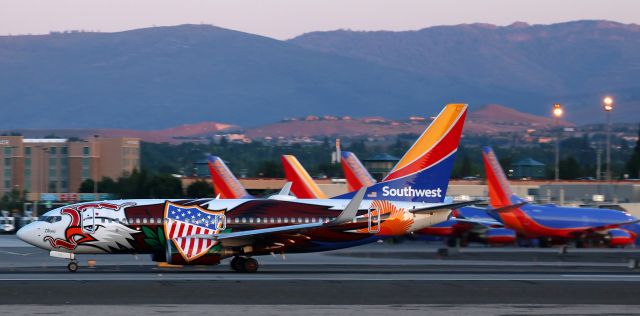 Boeing 737-700 (N918WN) - Six SWA fleetbirds did their RON time at RNO, and this shot captures the first of the six, "Illinois One" (N918WN), departing on runway 16R as the dawn light gradually begins to brighten up the morning sky over Reno Tahoe International.  I was feeling quite happy about catching this scheme, but as I snapped this shot, little did I know that this special paint was just the first of many special livery aircraft that I would be clicking throughout this day.