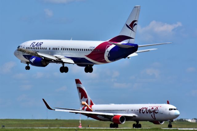 BOEING 737-400 (C-FLHE) - Flair Airlines Boeing 737-490 arriving at YYC on Aug 4 while Air Canada Rouge Boeing 767-316(ER)(WL) gets ready to depart.