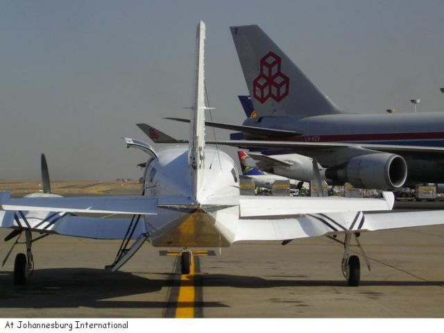 Cessna 402 (ZS-MPC) - Parked near the freighters at FAJS, Johannesburg, South Africa