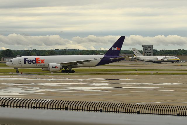 BOEING 777-200LR (N893FD) - ADB A-124-100M UR-82007 on the postal ramp in the background.