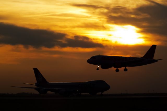 BOEING 747-8 (LX-VCA) - LX-VCA waiting to take off while G-EZAM landing in beautiful sunset at LHBP, Budapest.