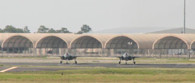 Lockheed F-35C — - F-35s waiting to taxi. I was driving north out of Destin passing Eglin AFB where they had numerous jets performing touch & gos. I pulled over and took photos of this impromptu airshow.