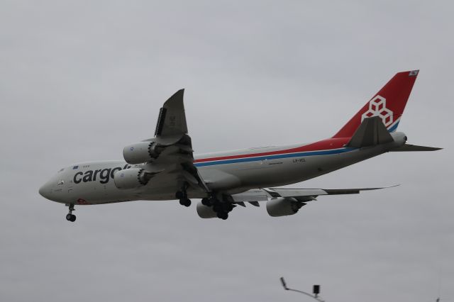 BOEING 747-8 (LX-VCL) -  "Spirit of Joe Sutter" screams over the Million Air lot. A rare appearance of Cargolux's 747-8. as opposed to the smaller 747-400.