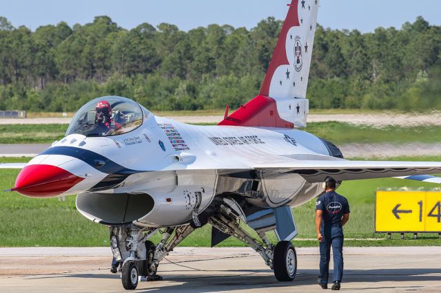 Lockheed F-16 Fighting Falcon — - The Thunderbirds show was about to begin at Tyndall Air Force base near Panama City Florida. The commander in Thunderbird #1 has his engine of the fire breathing dragon starting and getting ready to start the show. I shot this with my Canon 300mm 2.8 lens. I turned up the aperture to get the entire aircraft in crisp focus. The camera settings were 1/640 shutter, F10, ISO 400. Please check out my other aviation photography. Votes and positive comments are always appreciated. Questions about this photo can be sent to Info@FlewShots.com