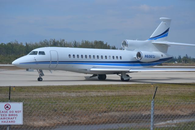 Dassault Falcon 7X (N606TJ) - Taken 2/4/2015 at the end of runway 5.  County and/or City of Naples built a small area with parking,  a playground for children and a raised deck with seats, sun protection and airport radio over speaker. Approximately 150 yards from runway.