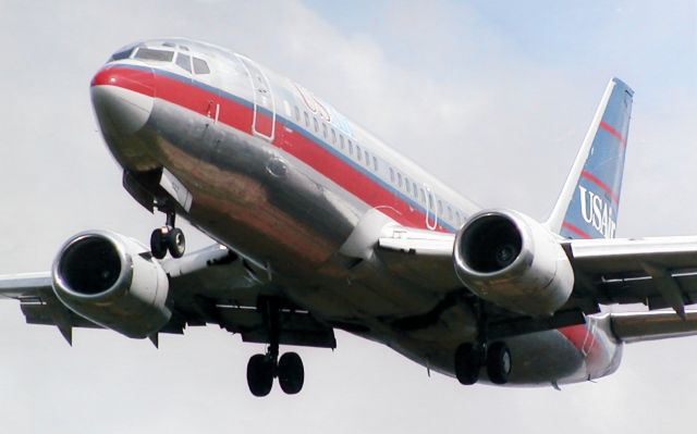 — — - US Air 737 arriving at Charlotte around 2000. Scanned from one of my prints.