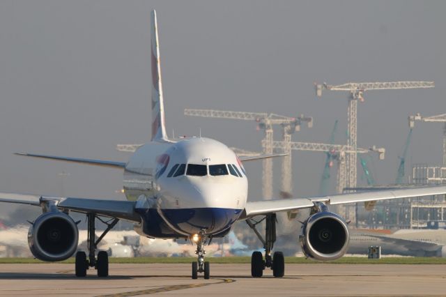 Airbus A319 (G-EUPC) - Manchester Airport uk New terminal construction well under way.        07-05-018 jroon