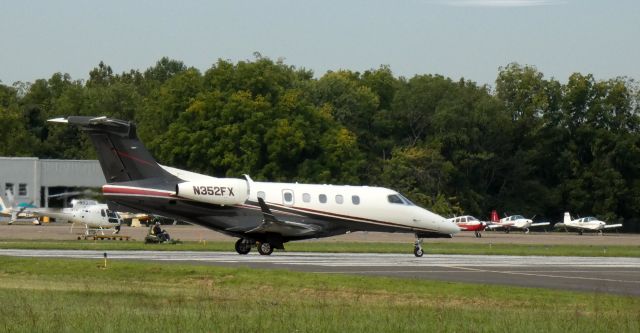 Embraer Phenom 300 (N352FX) - On the departing runway is this 2012 Embraer Phenom 505 from the Summer of 2020.