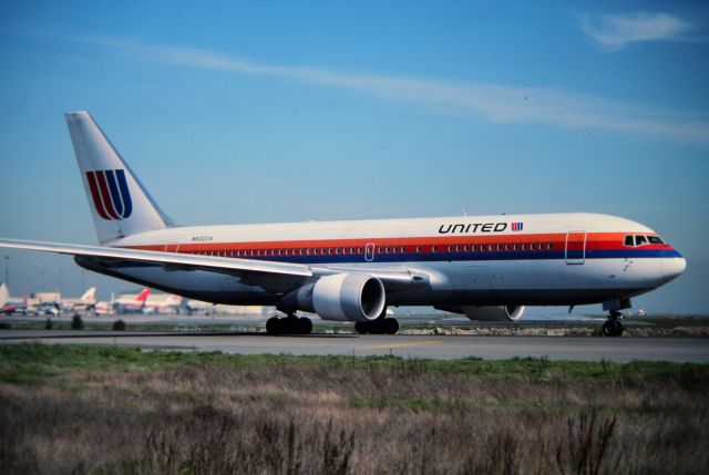 BOEING 767-200 (N602UA) - KSFO - then new 767-200 for United easing out to 1R departure runway. Late 1980s photo.