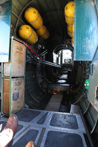 Consolidated B-24 Liberator (N224J) - Collings Foundation "Wings of Freedom Tour," 9 Apr 16, at Marana Regional Airport, AZ.  B-24J, Witchcraft, NX224J.  Sitting on the floor at the left waist gun position looking aft.