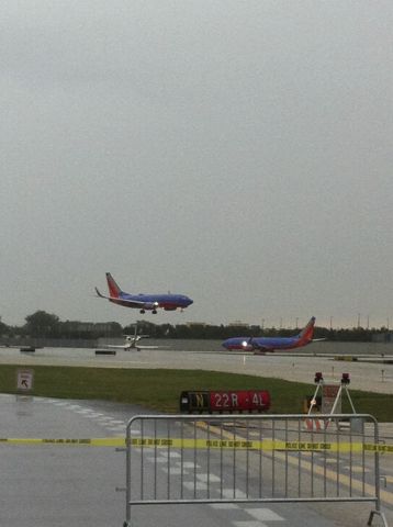 Boeing 737-700 — - Taken during the 5k on the runway at KMDW. Aircraft landing on 22L, while a second aircraft holds short of 22L at W.