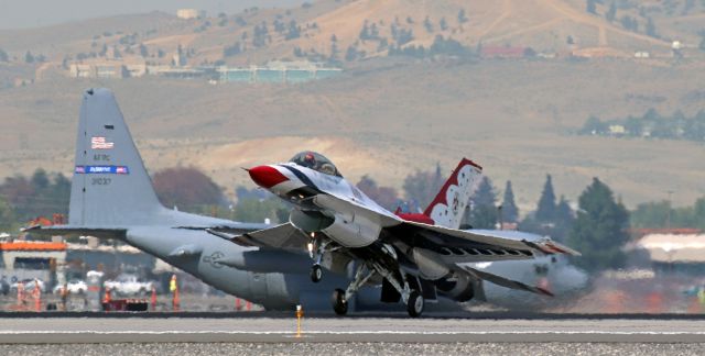 Lockheed F-16 Fighting Falcon — - Flying Thunderbird #1, the Thunderbirds Squadron CO has just touched down on Runway 16L while, in the background, a Dobbins ARB*-based C-130H, 93-1037, waits on Alpha at the 16L "Hold" line for more F-16 Thunderbirds to land.br /* Dobbins Air Reserve Base, Georgia. (Formerly Dobbins AFB)