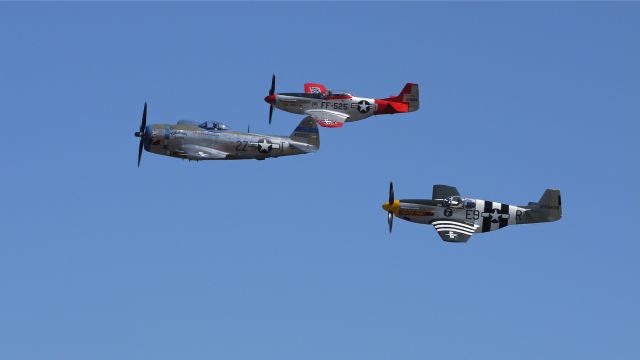 North American P-51 Mustang (N5087F) - A P51D (VAL-HALLA), P51B (IMPATIENT VIRGIN?) and P47D (TALLAHASSEE LASSIE) make a low pass at Vintage Aircraft Weekend. Photographed 9/3/11.