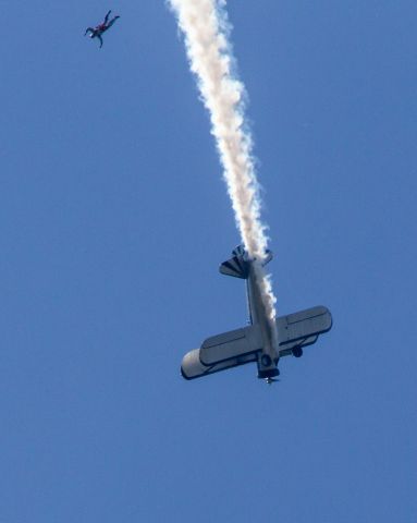 Beechcraft Baron (58) (N68853) - The Flying Circus starts with a sky diver dropping in with the American flag.