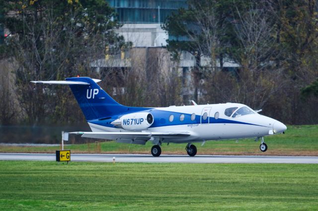 Beechcraft Beechjet (N671UP) - N671UP is a 2005 Hawker 400A seen here touching down at Atlanta's PDK executive airport. I shot this with a Canon 500mm lens. Camera settings were 1/2000 shutter, F4, ISO 800. Please check out my other photography. Votes and positive comments are always appreciated. Questions about this photo can be sent to Info@FlewShots.com