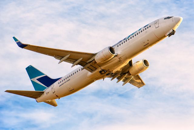 Boeing 737-800 (C-GWSR) - Taking off Runway 29 in Calgary, Alberta near sunset