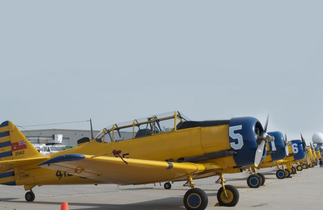 North American T-6 Texan (C-FVMG) - C-FVMG and a line of T-6s HARVARDS (TEXANS) awaiting time to perform at 40th Anniversary Hamilton AirShow, June 2012.