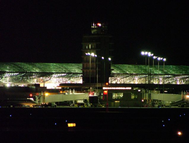 — — - Night shot of ATC tower and main terminal.