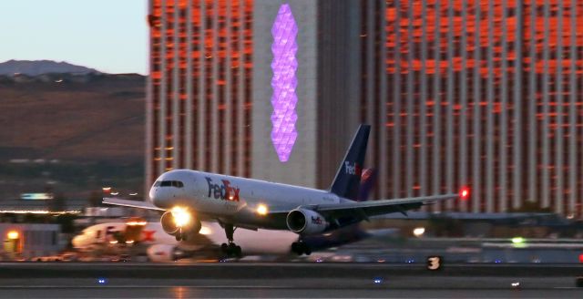 Boeing 757-200 (N937FD) - N937FD, Fed Ex's B752 named "Aley," is almost lost in all the multicolor lights as it is just about to touch down on runway 16R at the end of a flight from Sky Harbor International in Phoenix (KPHX-KRNO).