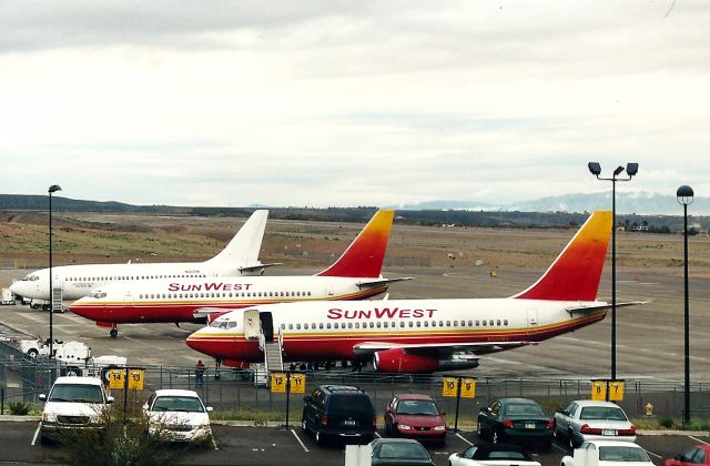 Boeing 737-200 (N920WA) - KIFP - Laughlin Bullhead City, AZ - Sunwest fleet caught on the ground at Laughlin. The middle jet is N705S and the Casino Express jet is N233TM in this Feb 2001 photo. View looking south.