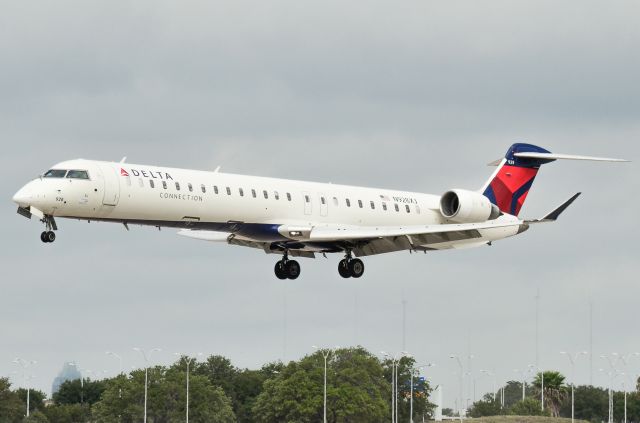 Canadair Regional Jet CRJ-900 (N928XJ) - From the official viewing area at Austin Bergstrom.