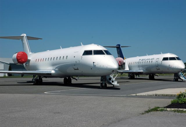 Canadair Regional Jet CRJ-200 — - A couple of Bombardier CRJ-200s lined up at CYPQ/YPQ on June 24, 2015. Note the one in the rear is painted in the Berjaya Air livery (9M-CRD).