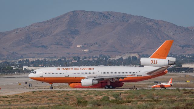 McDonnell Douglas DC-10 (N17085) - Tanker 911 Taxing past a SIAI-Marchetti S-211 in a similar color paint scheme.  911 was getting ready to take off to help fight the Canyon fire in Orange County California. The S-211 was down in the worst of the heat distortion given off of the taxi ways that morning.