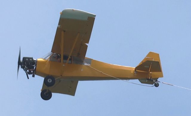 Piper L-21 Super Cub (N1259A) - A 1951 Piper PA-18-125 -- registered to High Exposure -- tows a banner ad over Rehoboth Beach, Delaware on June 29, 2024
