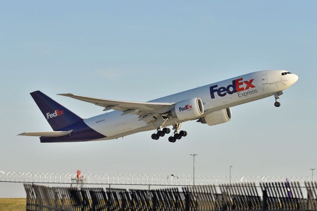 BOEING 777-200LR (N861FD) - 23-L 11-28-23. Being kissed by that golden hour winter light.