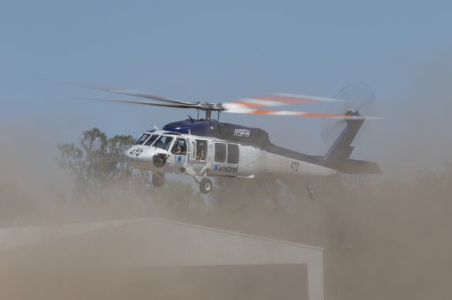 Sikorsky S-70 (N9FH) - Firebird 470 getting airborne in dusty conditions bound for our bushfires to do some waterbombing.